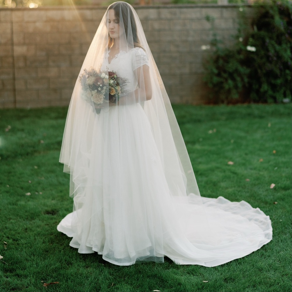 Sheer Drop Bridal Veil, waist length blusher in Light Ivory with a raw edge.